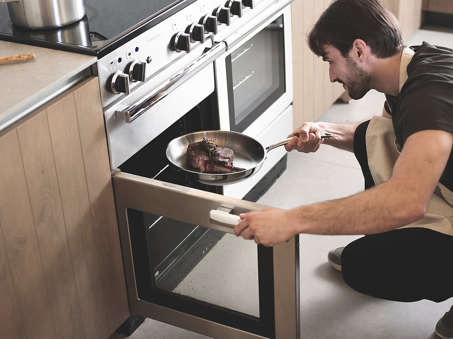 Stainless steel frying pan going into an oven